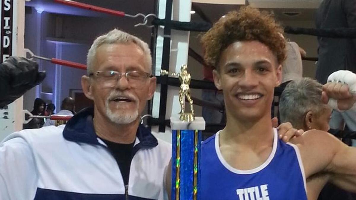Avaon Graham, of Belleville, won his first St. Louis Golden Gloves boxing championship at 132 pounds. He is trained at the Belleville Boxing Club by Ken Reilly, left.