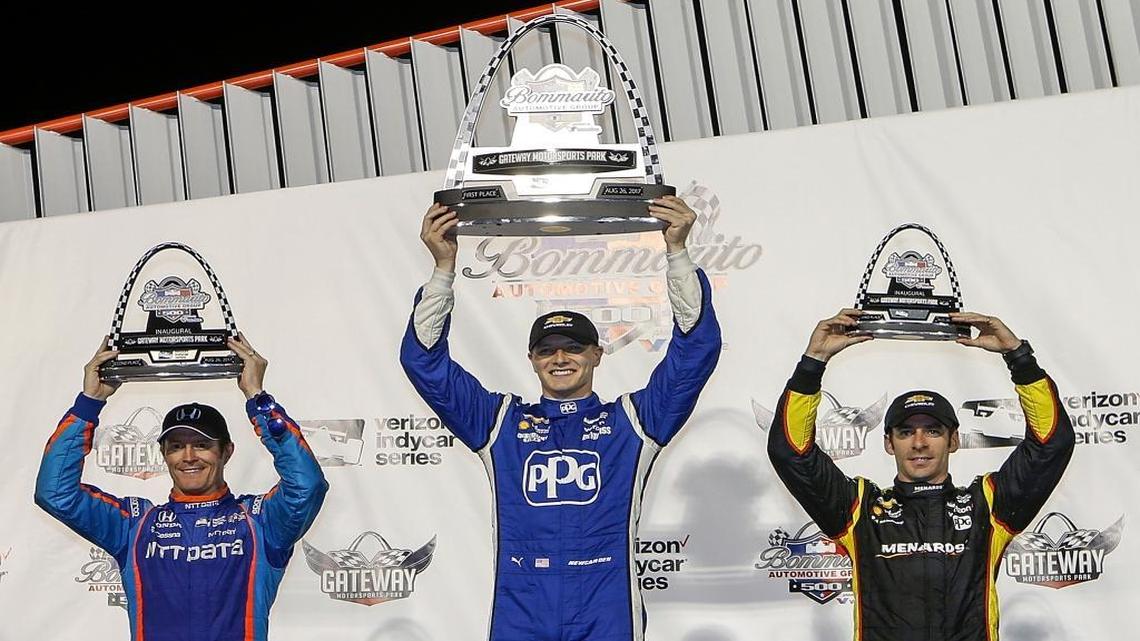 Josef Newgarden, center, celebrates his win, while standing next to second-place Scott Dixon, left, of New Zealand, and third-place Simon Pagenaud, of France, after the IndyCar auto race Saturday, Aug. 26, 2017, at Gateway Motorsports Park in Madison, Ill.