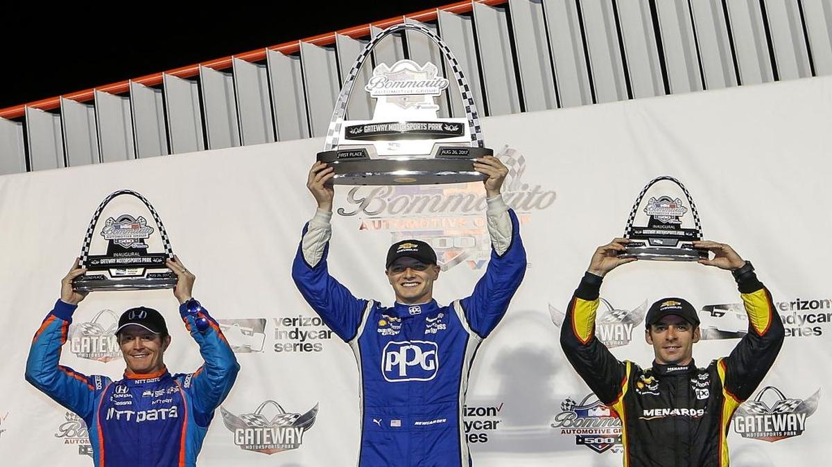 Josef Newgarden, center, celebrates his win, while standing next to second-place Scott Dixon, left, and third-place Simon Pagenaud after the IndyCar auto race Saturday at Gateway Motorsports Park in Madison.