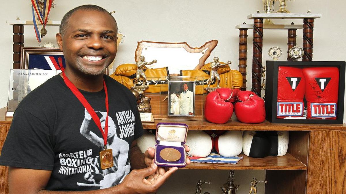 Olympic boxer Arthur Johnson wears the gold medal he received at the 1986 Goodwill Games in Russia, and is holding a Bronze medallion he received from the 1988 Olympics in Seoul. See a gallery of photographs at bnd.com.