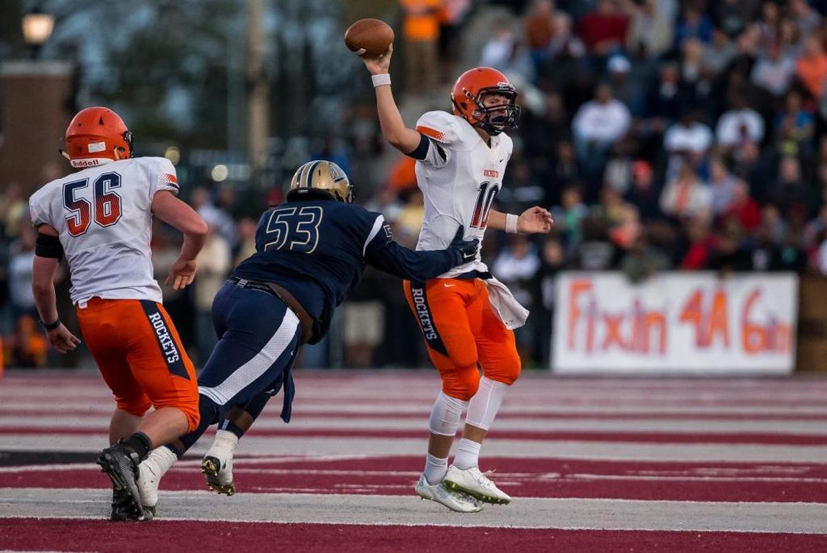 Althoff's Devyn Nash (53) pressures Rochester quarterback Danny Zeigler (10) during the 2015 Class 4A playoffs at Lindenwood University-Belleville.