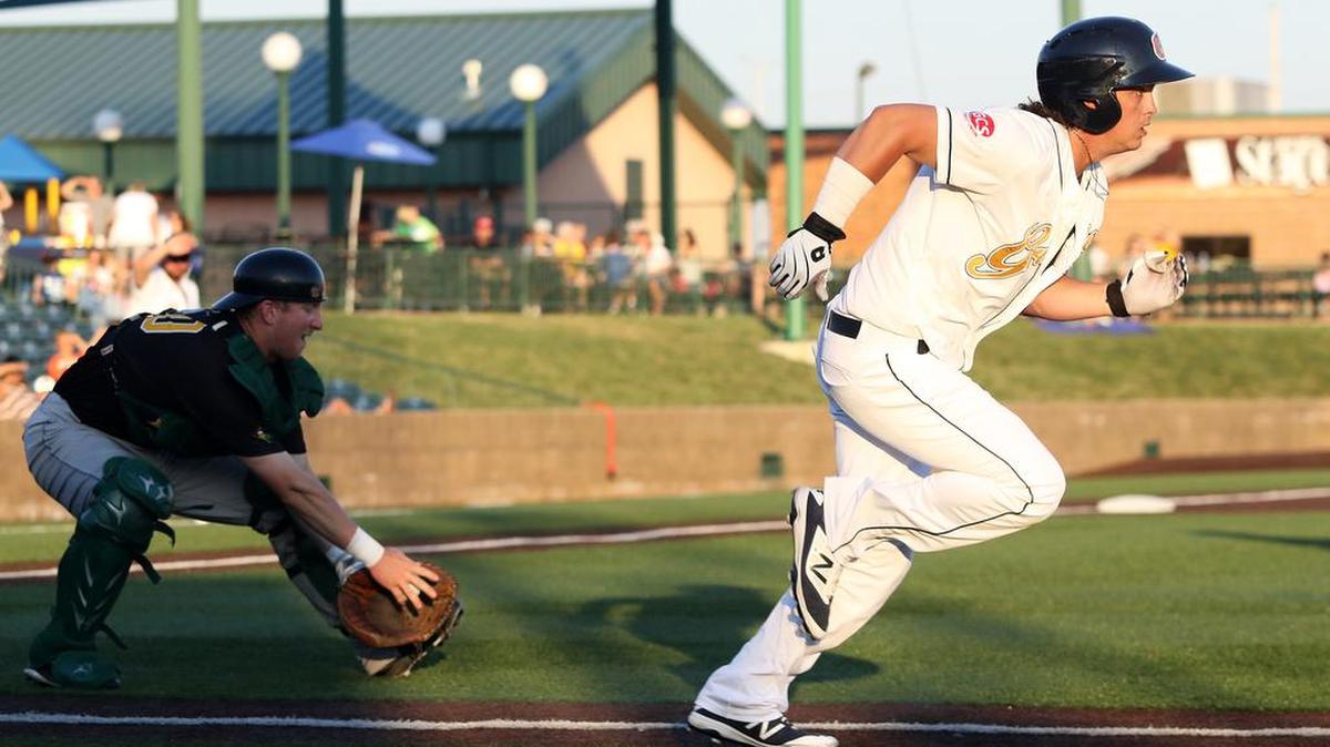The Gateway Grizzlies’ Cody Livesay hits a high chopper in front of the plate and runs to first while the Normal Cornbelters’ catcher Dylan Kelley picks up the ball and throws out Livesay during Saturday evening’s Frontier League game at GCS Ballpark. The Grizzlies lost 3-2 after giving up two solo home runs in the ninth inning. See a gallery of photographs at bnd.com.